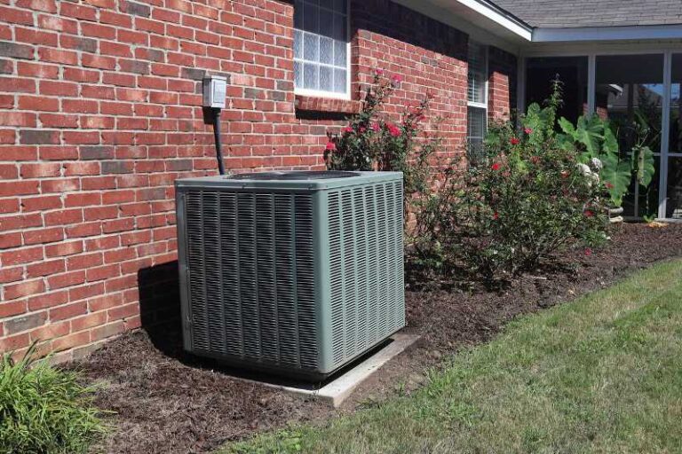 AC unit against brick wall