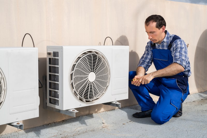 technician making AC repairs